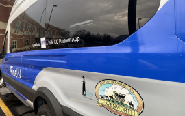 Photo of Ford Transit 350 van in blue and white with "RideLV" logo, City of Leavenworth logo and The Guidance Center logo