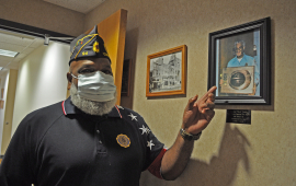 Rick Fields points out a photograph of his father, Charles Fields, First African American Firefighter in the city of Leavenworth