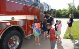 children looking at fire truck
