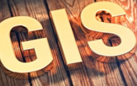Image of a yellow sign text above woodgrain with words GIS