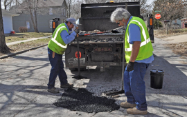 City workers do street patching repair along Ottawa Street.