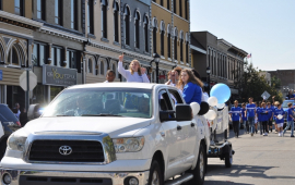 parade photo of girl riding in vehicle