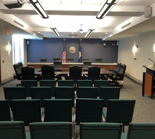 City Commission chambers, room with chairs and a Leavenworth logo