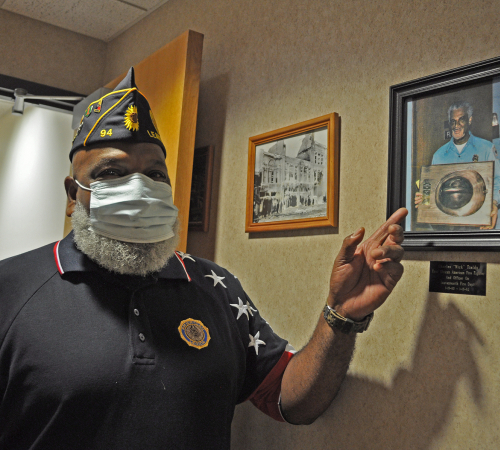 Rick Fields points out a photograph of his father, Charles Fields, First African American Firefighter in the city of Leavenworth