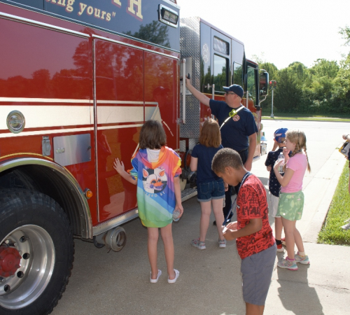 children looking at fire truck
