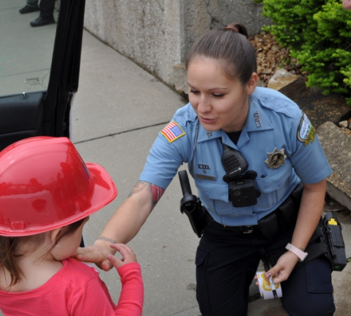 Police Officer gives a child a sticker.