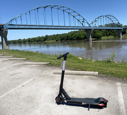 photo of a motorized scooter in front of Leavenworth bridge
