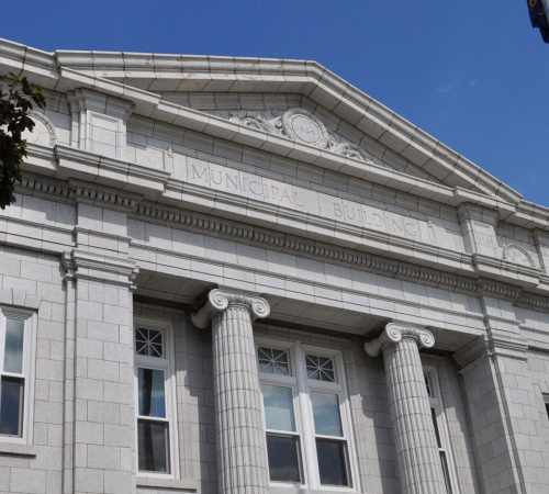 photo of city hall building with flag