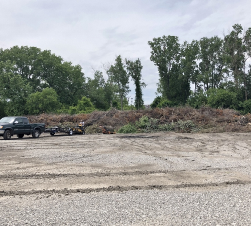 photo of truck next to large open brush pile at brush site