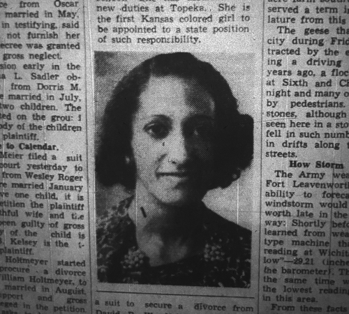 Newspaper clipping with picture of a young woman with curly hair and dark skin wearing earrings and flowered print dress