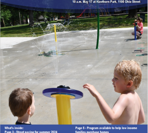 Photo of the front page of the newsletter shows a photo of two young boys pushing the button at the Leavenworth Splash pad
