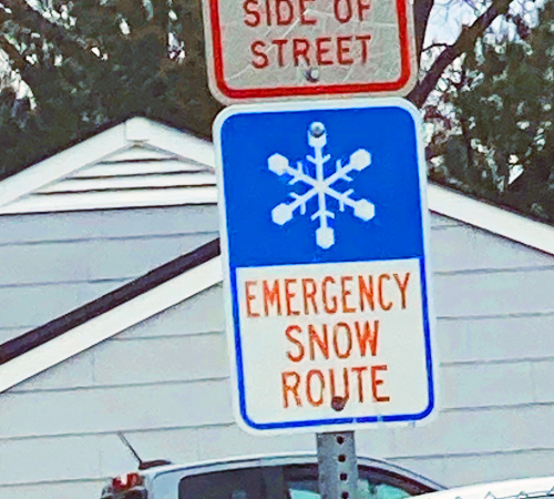 Emergency Snow Route sign with blue and white snowflake