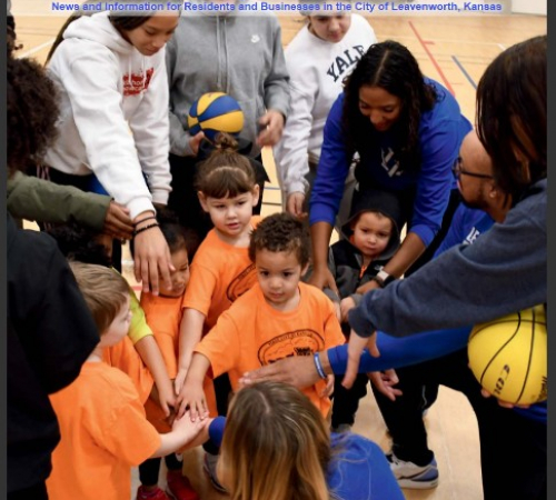 cover of First city connection magazine with photo of children putting their hands in a circle with a coach with a basketball