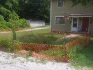 Orange fencing around a sink hole