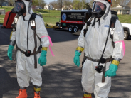 Firefighters in chemical hazardous material safety suits