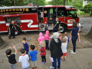Firefighter talks to children