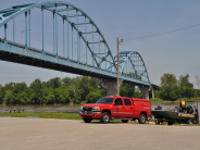 Fire staff standing around boat and fire pickup vehicle near boat ram