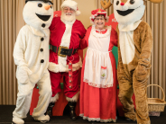 Group Photo of Santa, Mrs. Claus, Snowman, and Reindeer at Breakfast with Santa