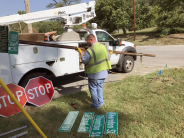 City workers fix road signs in Leavenworth in 2018.