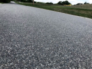 Granite seal is a process that covers the city streets with gravel material. Excess is later swept up.