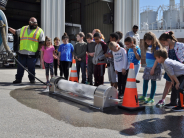 Children watch a demonstration of a specialized vehicle that clears debris from sewers at WPC in 2019.