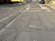 Road shows cracked pavement on Kiowa Street