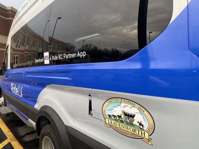 Photo of Ford Transit 350 van in blue and white with "RideLV" logo, City of Leavenworth logo and The Guidance Center logo