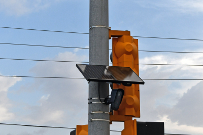 Photo shows a black panel mounted to a traffic safety light