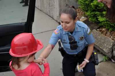 Police Officer gives a child a sticker.
