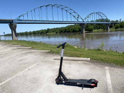 photo of a motorized scooter in front of Leavenworth bridge