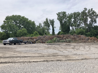 photo of truck next to large open brush pile at brush site