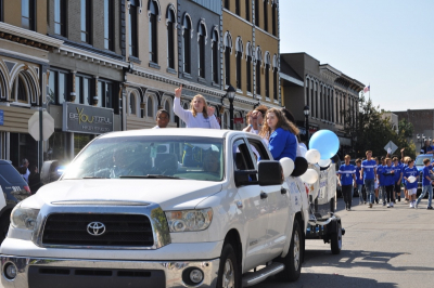 parade photo of girl riding in vehicle