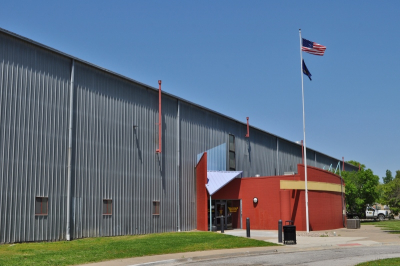 photo of large building with American and Kansas flags out front