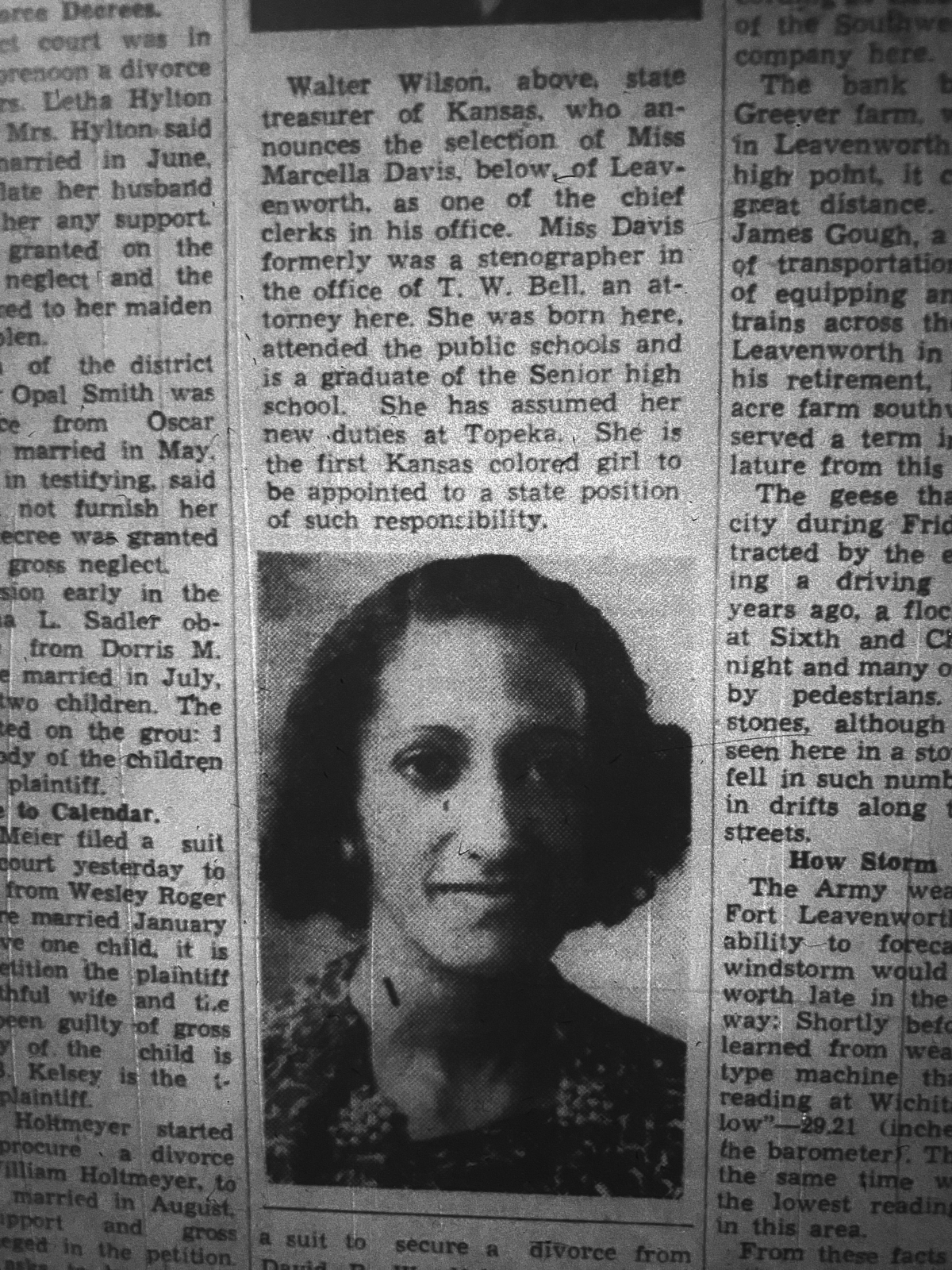 Newspaper clipping with picture of a young woman with curly hair and dark skin wearing earrings and flowered print dress