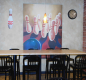 Table and chairs in the snack bar under an image of bowling pins.