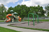 Playground equipment at David Brewer Park includes swings, slide